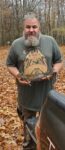 Andrew McDaniel of Bristol, Va. shows off a squirrel killed on a foggy autumn morning
