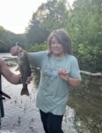 Hannah Rakes of Chapmanville with the first fish she ever caught. 