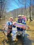 Patrick Griffith of Morgantown with his daughters Harlow Creek, 8 months and Hadley River age 4, celebrating an 8 pound rainbow trout on the Tygart River headwaters during a family fishing adventure. 
