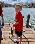 Rick Mallory of South Charleston, W.Va. shows off a picture of his grandson Tanner who had the biggest fish of the day during a trip to Flat Top Lake in Ghent, W.Va.  